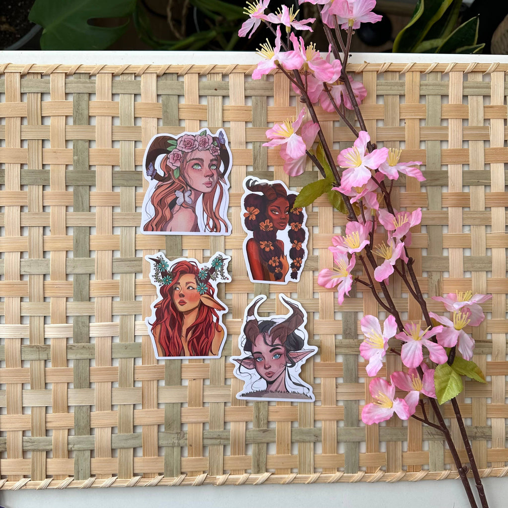 Set of stickers with illustrated characters on a woven mat with pink flowers.